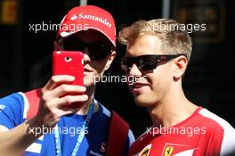 Sebastian Vettel (GER) Ferrari with a fan. 20.08.2015. Formula 1 World Championship, Rd 11, Belgian Grand Prix, Spa Francorchamps, Belgium, Preparation Day.