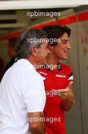 (L to R): Carlos Sainz (ESP) with Roberto Merhi (ESP) Manor Marussia F1 Team. 17.04.2015. Formula 1 World Championship, Rd 4, Bahrain Grand Prix, Sakhir, Bahrain, Practice Day