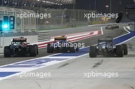 Lewis Hamilton (GBR) Mercedes AMG F1 W06 (Right) passes Carlos Sainz Jr (ESP) Scuderia Toro Rosso STR10 (Left) and Marcus Ericsson (SWE) Sauber C34 (Centre) in the pits. 17.04.2015. Formula 1 World Championship, Rd 4, Bahrain Grand Prix, Sakhir, Bahrain, Practice Day