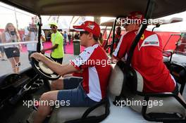 Sebastian Vettel (GER) Ferrari drives a golf buggy with Kimi Raikkonen (FIN) Ferrari and Britta Roeske (AUT) Ferrari Press Officer. 17.04.2015. Formula 1 World Championship, Rd 4, Bahrain Grand Prix, Sakhir, Bahrain, Practice Day