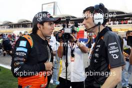 (L to R): Sergio Perez (MEX) Sahara Force India F1 with Tim Wright (GBR) Sahara Force India F1 Team Race Engineer on the grid. 19.04.2015. Formula 1 World Championship, Rd 4, Bahrain Grand Prix, Sakhir, Bahrain, Race Day.
