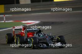 Nico Rosberg (GER) Mercedes AMG F1 W06 leads Sebastian Vettel (GER) Ferrari SF15-T. 19.04.2015. Formula 1 World Championship, Rd 4, Bahrain Grand Prix, Sakhir, Bahrain, Race Day.