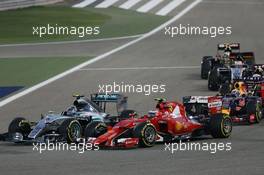 Nico Rosberg (GER) Mercedes AMG F1 W06 and Kimi Raikkonen (FIN) Ferrari SF15-T at the start of the race. 19.04.2015. Formula 1 World Championship, Rd 4, Bahrain Grand Prix, Sakhir, Bahrain, Race Day.