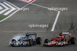 (L to R): Nico Rosberg (GER) Mercedes AMG F1 W06 locks up under braking as he battle for position with Kimi Raikkonen (FIN) Ferrari SF15-T. 19.04.2015. Formula 1 World Championship, Rd 4, Bahrain Grand Prix, Sakhir, Bahrain, Race Day.
