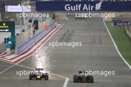 (L to R): Daniil Kvyat (RUS) Red Bull Racing RB11 and Fernando Alonso (ESP) McLaren MP4-30 battle for position. 19.04.2015. Formula 1 World Championship, Rd 4, Bahrain Grand Prix, Sakhir, Bahrain, Race Day.