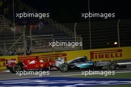 Nico Rosberg (GER) Mercedes AMG F1 W06 and Sebastian Vettel (GER) Ferrari SF15-T battle for position. 19.04.2015. Formula 1 World Championship, Rd 4, Bahrain Grand Prix, Sakhir, Bahrain, Race Day.