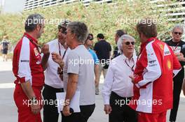 (L to R): Maurizio Arrivabene (ITA) Ferrari Team Principal with Pasquale Lattuneddu (ITA) of the FOM and Eddie Jordan (IRE) BBC Television Pundit; Bernie Ecclestone (GBR) with Gino Rosato (CDN) Ferrari. 19.04.2015. Formula 1 World Championship, Rd 4, Bahrain Grand Prix, Sakhir, Bahrain, Race Day.