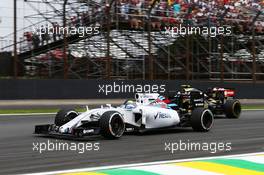 Felipe Massa (BRA) Williams FW37 and Romain Grosjean (FRA) Lotus F1 E23 battle for position. 15.11.2015. Formula 1 World Championship, Rd 18, Brazilian Grand Prix, Sao Paulo, Brazil, Race Day.