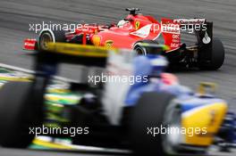Sebastian Vettel (GER) Ferrari SF15-T leads Felipe Nasr (BRA) Sauber C34. 15.11.2015. Formula 1 World Championship, Rd 18, Brazilian Grand Prix, Sao Paulo, Brazil, Race Day.