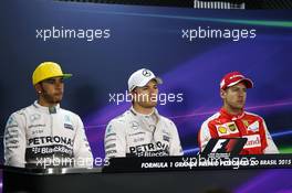 (L to R): Lewis Hamilton (GBR) Mercedes AMG F1 with team mate Nico Rosberg (GER) Mercedes AMG F1 and Sebastian Vettel (GER) Ferrari in the post qualifying FIA Press Conference. 14.11.2015. Formula 1 World Championship, Rd 18, Brazilian Grand Prix, Sao Paulo, Brazil, Qualifying Day.