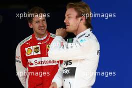Sebastian Vettel (GER) Ferrari and Nico Rosberg (GER) Mercedes AMG F1 W06, 14.11.2015. Formula 1 World Championship, Rd 18, Brazilian Grand Prix, Sao Paulo, Brazil, Qualifying Day.