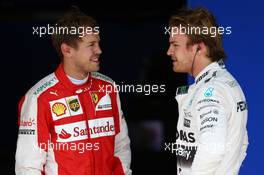 Sebastian Vettel (GER) Ferrari SF15-T and Nico Rosberg (GER) Mercedes AMG F1 W06. 14.11.2015. Formula 1 World Championship, Rd 18, Brazilian Grand Prix, Sao Paulo, Brazil, Qualifying Day.