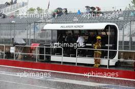 McLaren pit gantry in the rain. 05.06.2015. Formula 1 World Championship, Rd 7, Canadian Grand Prix, Montreal, Canada, Practice Day.