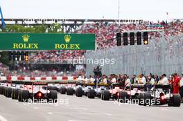 Max Verstappen (NLD) Scuderia Toro Rosso STR10 and Jenson Button (GBR) McLaren MP4-30 at the back of the race before the start of the race. 07.06.2015. Formula 1 World Championship, Rd 7, Canadian Grand Prix, Montreal, Canada, Race Day.