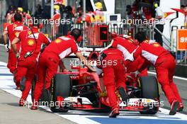 Sebastian Vettel (GER) Ferrari SF15-T is pushed back in the pits. 10.04.2015. Formula 1 World Championship, Rd 3, Chinese Grand Prix, Shanghai, China, Practice Day.