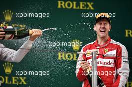 Sebastian Vettel (GER) Ferrari celebrates his third position with the champagne on the podium. 12.04.2015. Formula 1 World Championship, Rd 3, Chinese Grand Prix, Shanghai, China, Race Day.