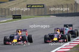 Daniil Kvyat (RUS) Red Bull Racing RB11 and Daniel Ricciardo (AUS) Red Bull Racing RB11 (Right) battle for position. 12.04.2015. Formula 1 World Championship, Rd 3, Chinese Grand Prix, Shanghai, China, Race Day.