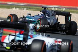 Lewis Hamilton (GBR) Mercedes AMG F1 W06 leads Felipe Massa (BRA) Williams FW37. 03.07.2015. Formula 1 World Championship, Rd 9, British Grand Prix, Silverstone, England, Practice Day.