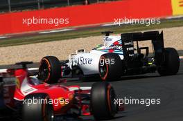 Felipe Massa (BRA) Williams FW37 leads Sebastian Vettel (GER) Ferrari SF15-T. 03.07.2015. Formula 1 World Championship, Rd 9, British Grand Prix, Silverstone, England, Practice Day.