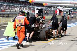 The Lotus F1 E23 of Romain Grosjean (FRA) Lotus F1 Team is recovered back to the pits by mechanics. 03.07.2015. Formula 1 World Championship, Rd 9, British Grand Prix, Silverstone, England, Practice Day.