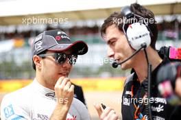 (L to R): Sergio Perez (MEX) Sahara Force India F1 with Tim Wright (GBR) Sahara Force India F1 Team Race Engineer on the grid. 05.07.2015. Formula 1 World Championship, Rd 9, British Grand Prix, Silverstone, England, Race Day.