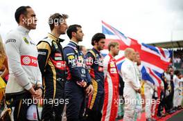 Pastor Maldonado (VEN) Lotus F1 Team and Romain Grosjean (FRA) Lotus F1 Team as the grid observes the national anthem. 05.07.2015. Formula 1 World Championship, Rd 9, British Grand Prix, Silverstone, England, Race Day.