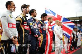 Pastor Maldonado (VEN) Lotus F1 Team and Romain Grosjean (FRA) Lotus F1 Team as the grid observes the national anthem. 05.07.2015. Formula 1 World Championship, Rd 9, British Grand Prix, Silverstone, England, Race Day.