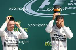(L to R): second placed Nico Rosberg (GER) Mercedes AMG F1 with talks with Lewis Hamilton (GBR) Mercedes AMG F1. 05.07.2015. Formula 1 World Championship, Rd 9, British Grand Prix, Silverstone, England, Race Day.