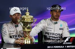 (L to R): Second placed Nico Rosberg (GER) Mercedes AMG F1 with the trophy of race winner Lewis Hamilton (GBR) Mercedes AMG F1 in the FIA Press Conference. 05.07.2015. Formula 1 World Championship, Rd 9, British Grand Prix, Silverstone, England, Race Day.