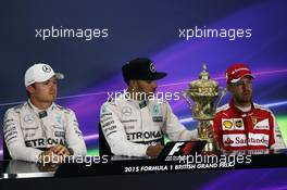 The post race FIA Press Conference (L to R): Nico Rosberg (GER) Mercedes AMG F1, second; Lewis Hamilton (GBR) Mercedes AMG F1, race winner; Sebastian Vettel (GER) Ferrari, third. 05.07.2015. Formula 1 World Championship, Rd 9, British Grand Prix, Silverstone, England, Race Day.