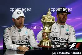 (L to R): Second placed Nico Rosberg (GER) Mercedes AMG F1 with the trophy of race winner Lewis Hamilton (GBR) Mercedes AMG F1 in the FIA Press Conference. 05.07.2015. Formula 1 World Championship, Rd 9, British Grand Prix, Silverstone, England, Race Day.