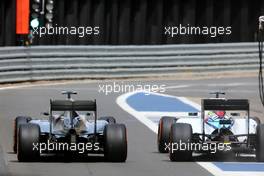 Nico Rosberg (GER) Mercedes AMG F1 W06 and Felipe Massa (BRA) Williams FW37 battle for position leaving the pits. 05.07.2015. Formula 1 World Championship, Rd 9, British Grand Prix, Silverstone, England, Race Day.