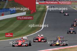 Kimi Raikkonen (FIN) Ferrari SF15-T and Daniil Kvyat (RUS) Red Bull Racing RB11 battle for position. 05.07.2015. Formula 1 World Championship, Rd 9, British Grand Prix, Silverstone, England, Race Day.