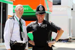 Neil Dickie (GBR) Sahara Force India F1 Team (Right) with a Policeman. 04.07.2015. Formula 1 World Championship, Rd 9, British Grand Prix, Silverstone, England, Qualifying Day.