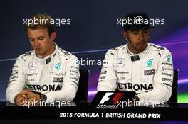 (L to R): Nico Rosberg (GER) Mercedes AMG F1 with team mate Lewis Hamilton (GBR) Mercedes AMG F1 in the FIA Press Conference. 04.07.2015. Formula 1 World Championship, Rd 9, British Grand Prix, Silverstone, England, Qualifying Day.