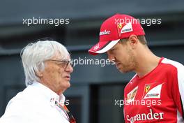 Bernie Ecclestone (GBR) and Sebastian Vettel (GER), Scuderia Ferrari  04.07.2015. Formula 1 World Championship, Rd 9, British Grand Prix, Silverstone, England, Qualifying Day.