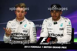 (L to R): Nico Rosberg (GER) Mercedes AMG F1 with team mate Lewis Hamilton (GBR) Mercedes AMG F1 in the FIA Press Conference. 04.07.2015. Formula 1 World Championship, Rd 9, British Grand Prix, Silverstone, England, Qualifying Day.