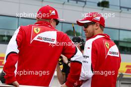 (L to R): Kimi Raikkonen (FIN) Ferrari with Sebastian Vettel (GER) Ferrari on the drivers parade. 05.07.2015. Formula 1 World Championship, Rd 9, British Grand Prix, Silverstone, England, Race Day.