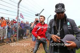 Lewis Hamilton (GBR) Mercedes AMG F1 and Will Stevens (GBR) Manor Marussia F1 Team with the fans. 05.07.2015. Formula 1 World Championship, Rd 9, British Grand Prix, Silverstone, England, Race Day.