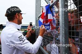 Jenson Button (GBR) McLaren with the fans. 05.07.2015. Formula 1 World Championship, Rd 9, British Grand Prix, Silverstone, England, Race Day.