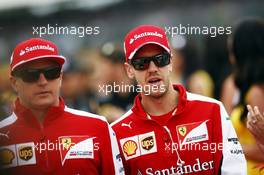 (L to R): Kimi Raikkonen (FIN) Ferrari and Sebastian Vettel (GER) Ferrari on the drivers parade. 05.07.2015. Formula 1 World Championship, Rd 9, British Grand Prix, Silverstone, England, Race Day.