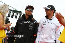 (L to R): Sergio Perez (MEX) Sahara Force India F1 with Jenson Button (GBR) McLaren on the drivers parade. 05.07.2015. Formula 1 World Championship, Rd 9, British Grand Prix, Silverstone, England, Race Day.