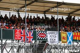 Fans and flags in the grandstand. 05.07.2015. Formula 1 World Championship, Rd 9, British Grand Prix, Silverstone, England, Race Day.