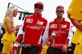 (L to R): Kimi Raikkonen (FIN) Ferrari with Sebastian Vettel (GER) Ferrari on the drivers parade. 05.07.2015. Formula 1 World Championship, Rd 9, British Grand Prix, Silverstone, England, Race Day.