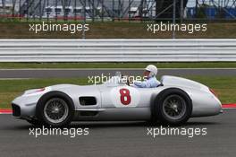 Stirling Moss (GBR) in the Mercedes W196. 05.07.2015. Formula 1 World Championship, Rd 9, British Grand Prix, Silverstone, England, Race Day.