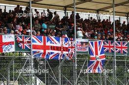 Fans and flags in the grandstand. 05.07.2015. Formula 1 World Championship, Rd 9, British Grand Prix, Silverstone, England, Race Day.