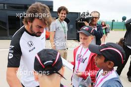Fernando Alonso (ESP) McLaren signs autographs for F1 in Schools Children. 02.07.2015. Formula 1 World Championship, Rd 9, British Grand Prix, Silverstone, England, Preparation Day.