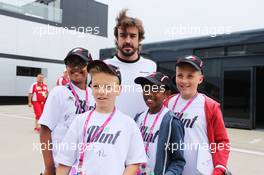 Fernando Alonso (ESP) McLaren with F1 in Schools Children. 02.07.2015. Formula 1 World Championship, Rd 9, British Grand Prix, Silverstone, England, Preparation Day.