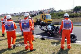 Marshals recover the Sahara Force India F1 VJM08 of Sergio Perez (MEX) after he crashed in the first practice session. 24.07.2015. Formula 1 World Championship, Rd 10, Hungarian Grand Prix, Budapest, Hungary, Practice Day.