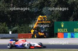 Fabio Leimer (SUI) Manor Marussia F1 Team Reserve Driver passes a circuit recovery vehicle. 24.07.2015. Formula 1 World Championship, Rd 10, Hungarian Grand Prix, Budapest, Hungary, Practice Day.